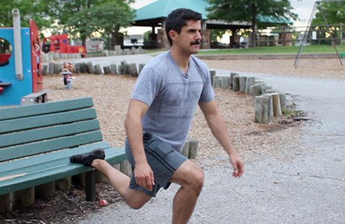 Vintage man doing Bulgarian split squat exercise.