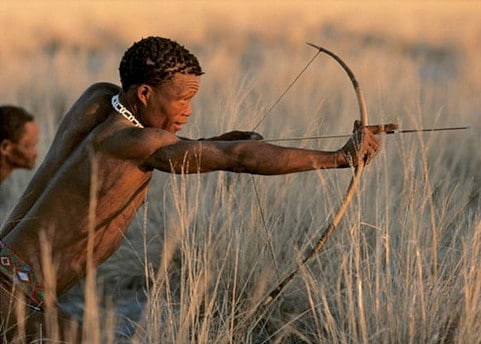 Bushmen young boy hunter with spear hunting gear.