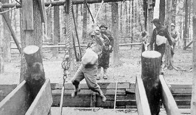 A group of men on a wooden platform in the woods, deep in contemplation of their vocation and responding to the obstacles that arise as they pursue their calling.