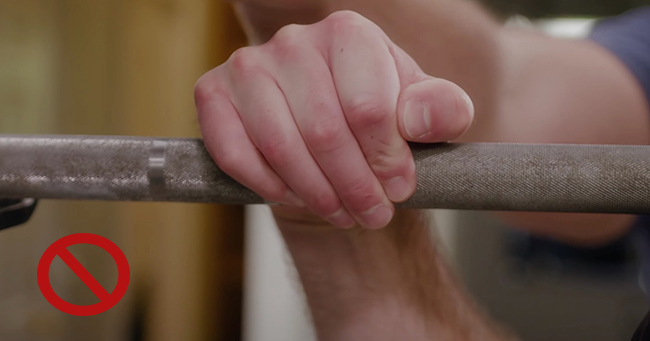 Wrong way of wrist extension while holding weight rod.