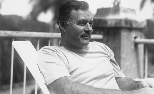 A black and white photo of a man sitting in a chair.