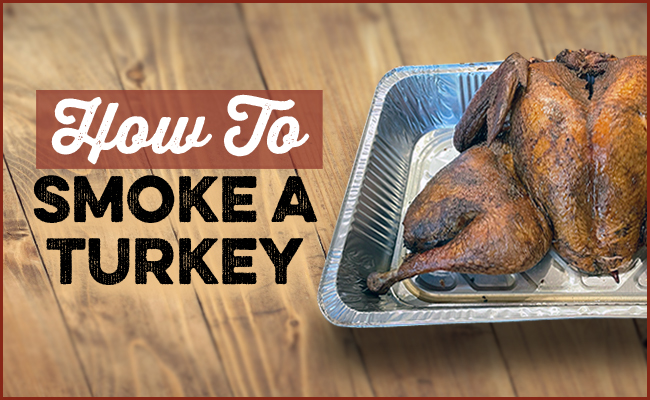 A smoked turkey sits in an aluminum tray on a wooden table, perfectly capturing how to smoke a turkey, next to text that reads, "How To Smoke A Turkey.
