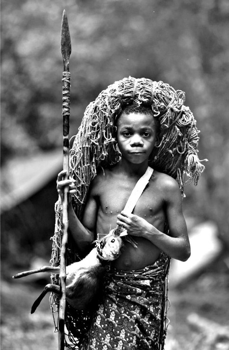 Vintage african young boy with spear hunting gear.