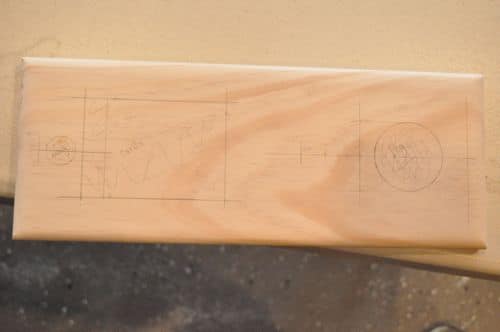 DIY wooden cribbage board marked for planning cards and peg holder.