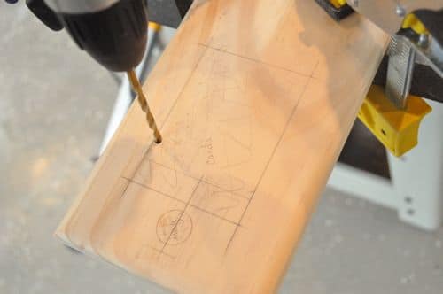 DIY of drilling holes in wooden cribbage board. 