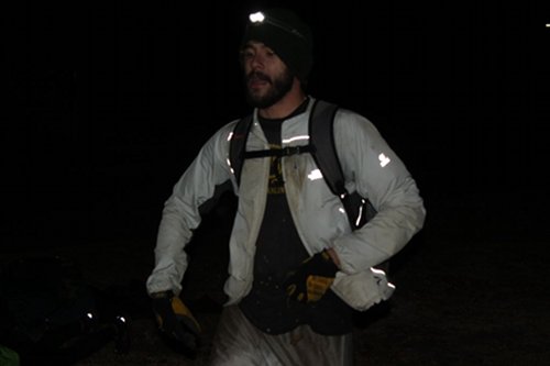 Men with beard wearing a bag from front side view.