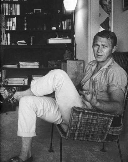 Steve mcqueen sitting on chair. 