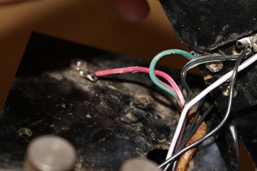 Vintage connecting a new red wire to it.