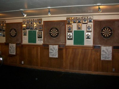 A game with several darts on a dart board.