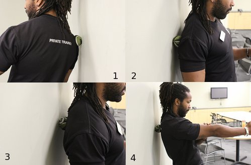 Vintage man placing ball between the wall and upperback.