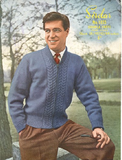 A man in a blue sweater is posing for a photo while following the Man's Guide to stylish sweaters.