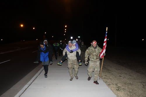 Men carrying a segment of the challenge.