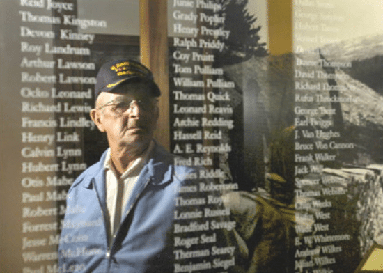 Marion James seeing memorial names on wall sheet.