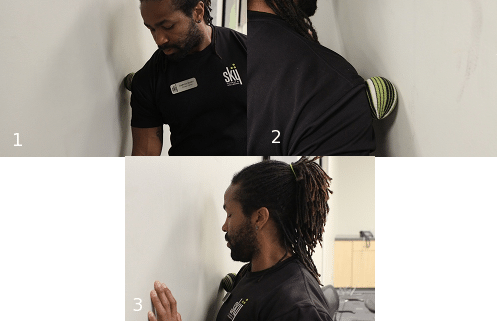 Place massage ball between you and wall.