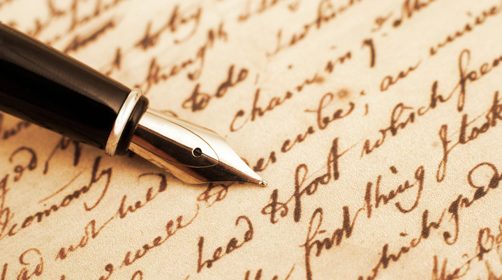 A fountain pen rests gracefully on a piece of paper.