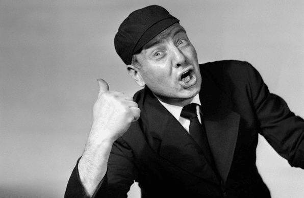A black and white photo of a man giving a thumbs up, symbolizing positivity in life.